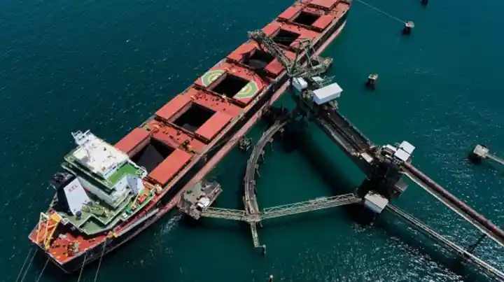 Bulk carrier loading coal at a jetty